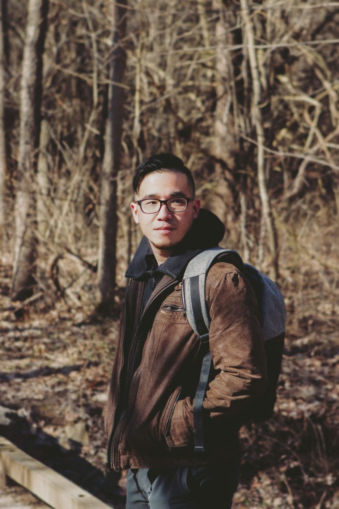 Man wearing backpack in the woods