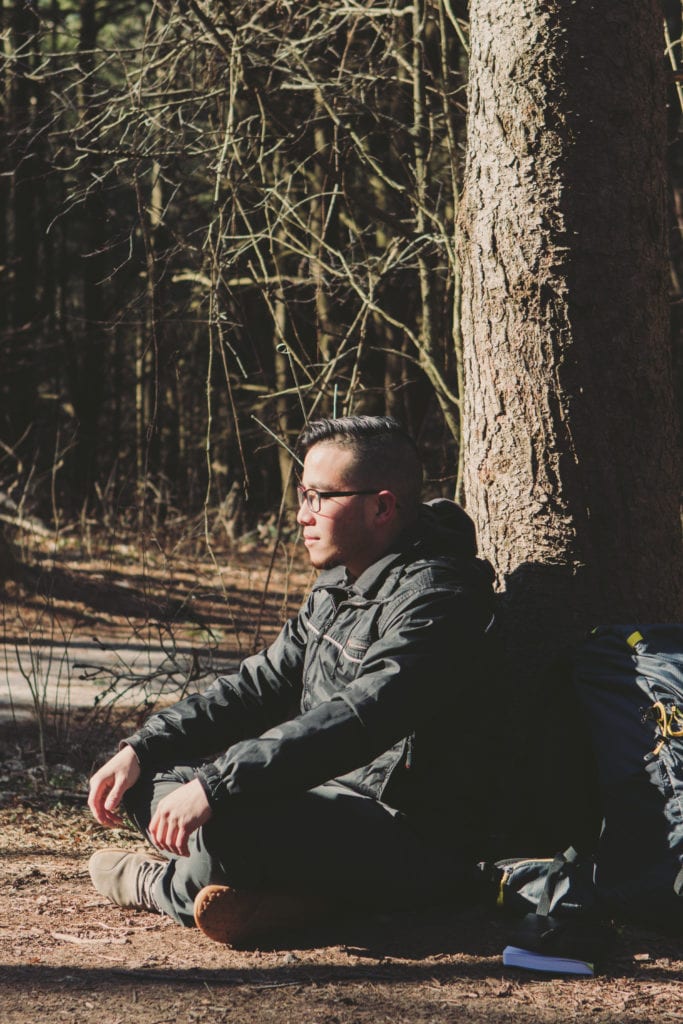 Man meditating in woods