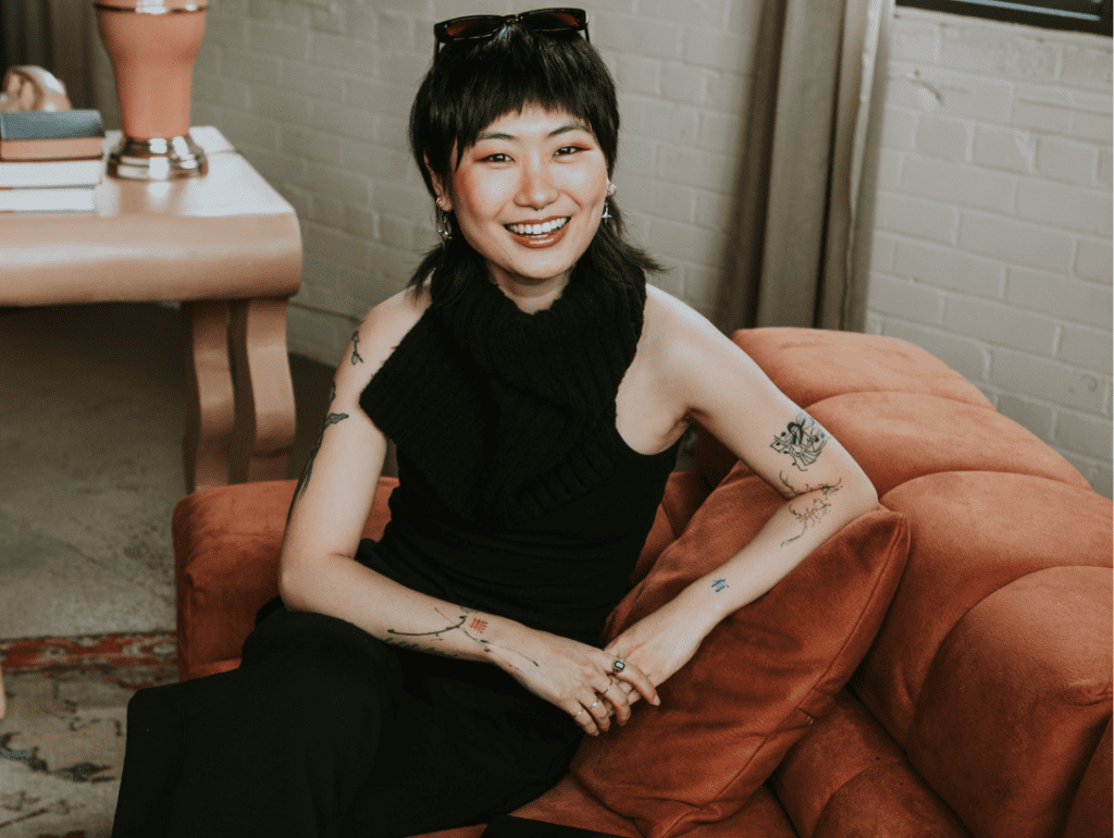 Personal brand photography of tattoo artist smiling at camera